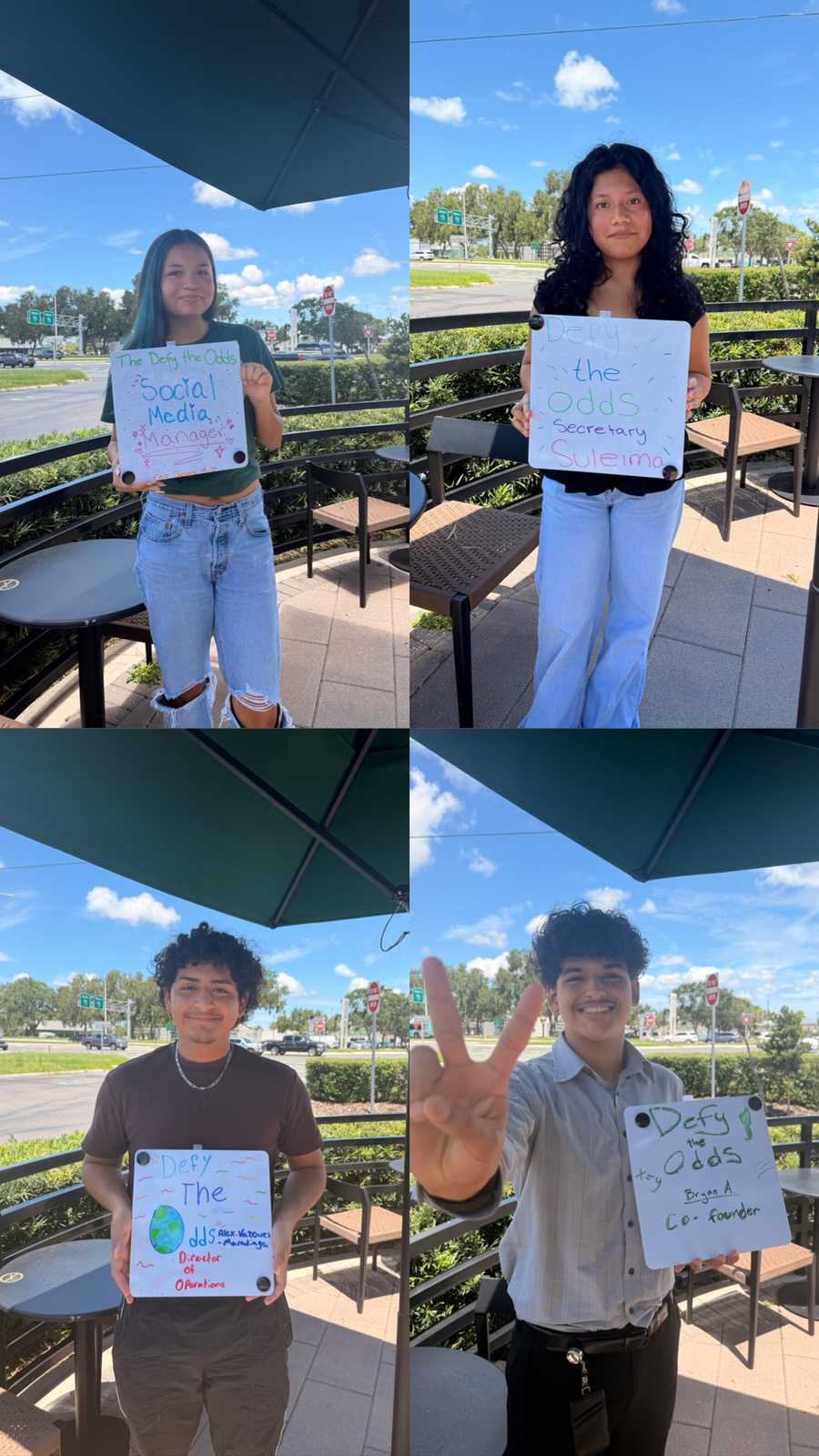 Team members holding Defy the Odds role signs